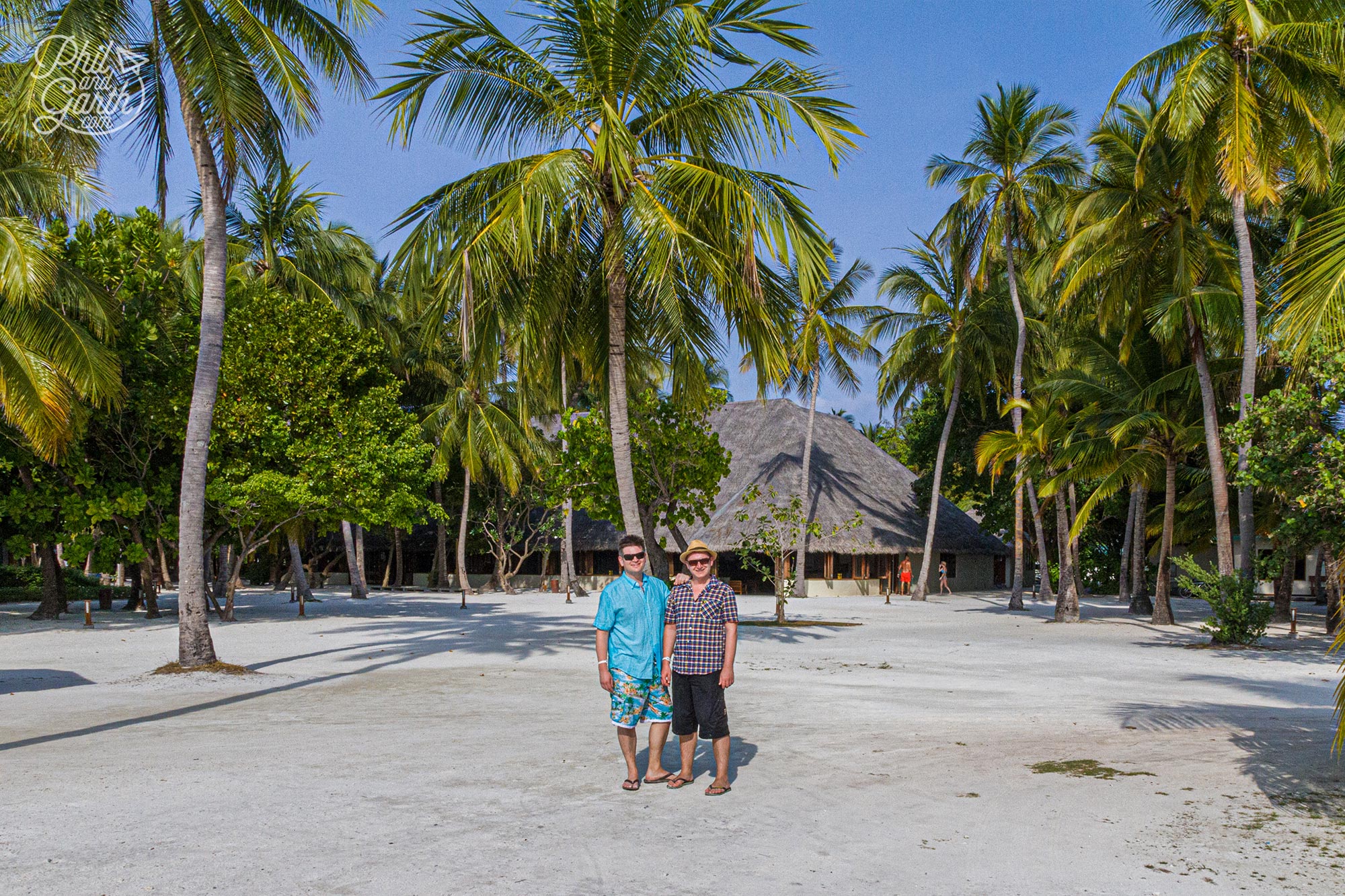 Phli and Garth surrounded by coconut palm trees