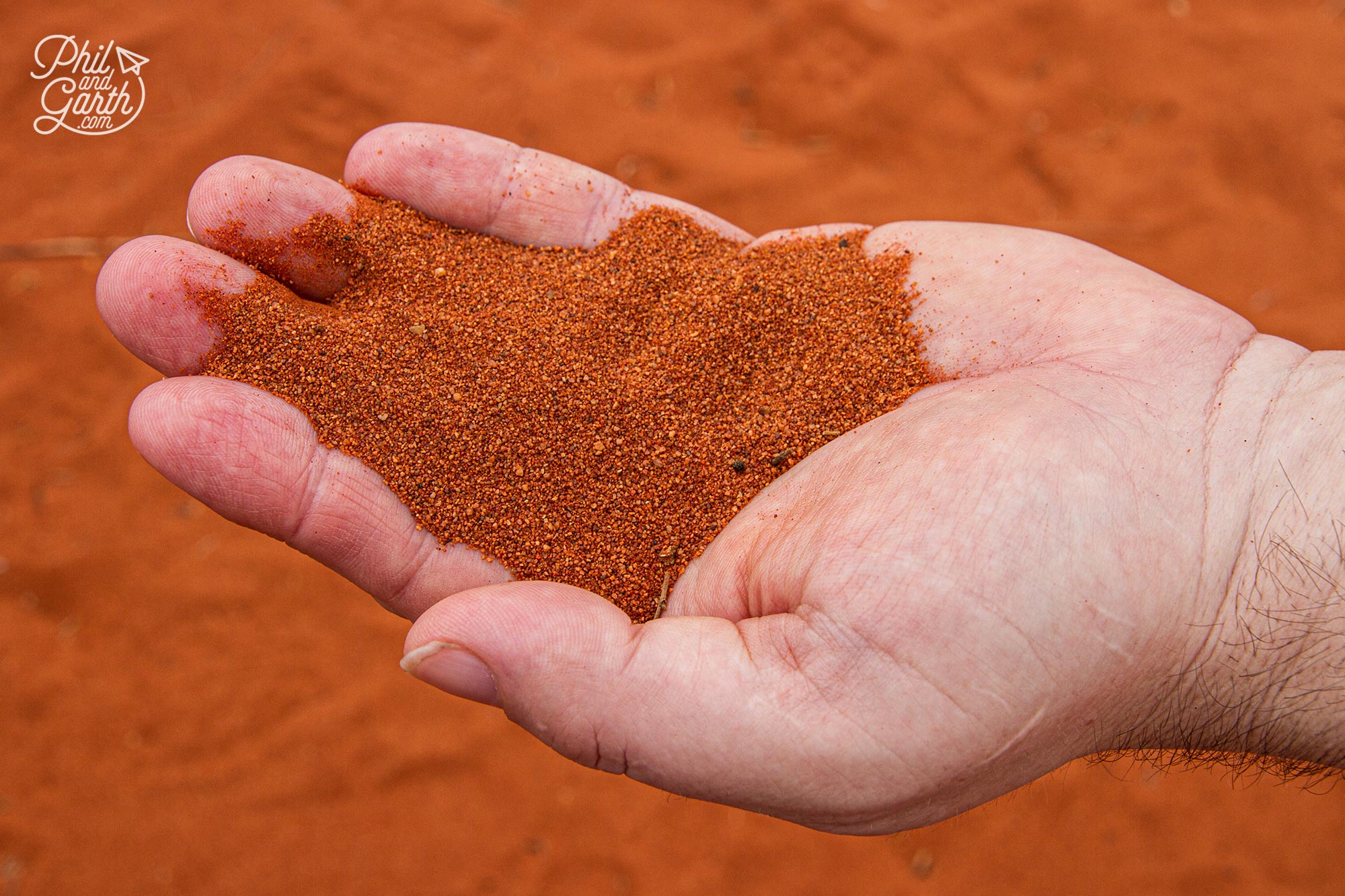 The rock and sand is red because of the iron in the rock which turns rusty