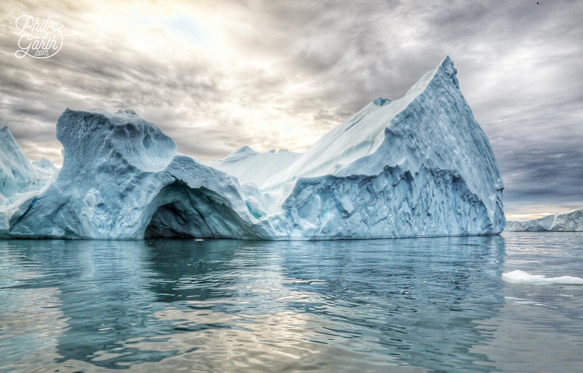 Water movements and the heat from the sun create caves in icebergs