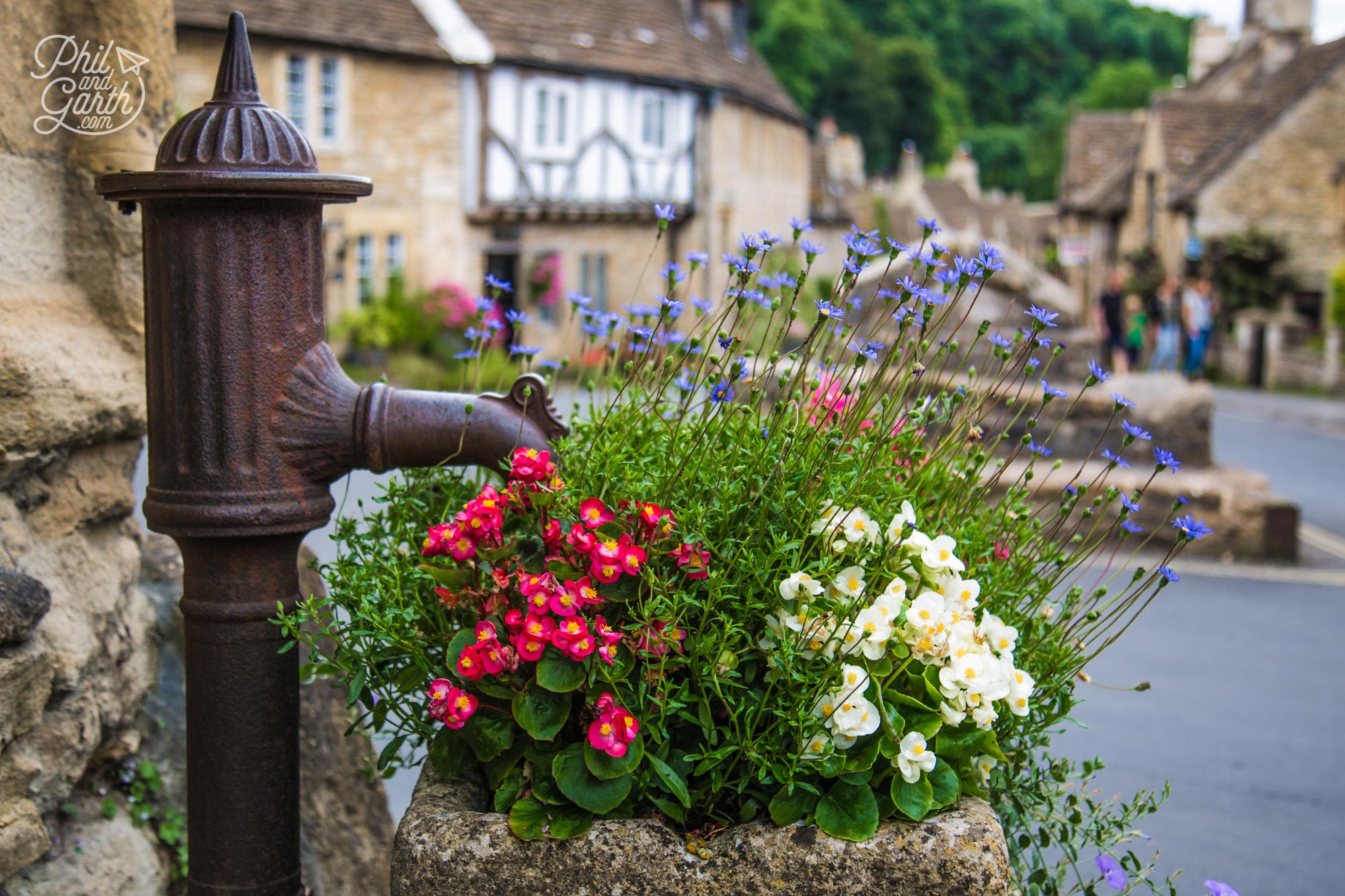 Castle Combe's flower filled village water pump