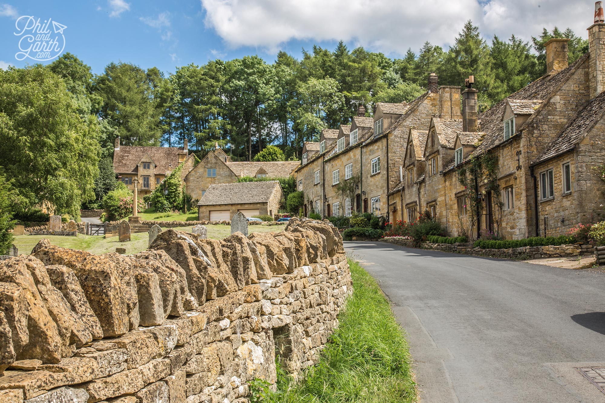 Snowshill dry stone wall and residential homes, The Cotswolds