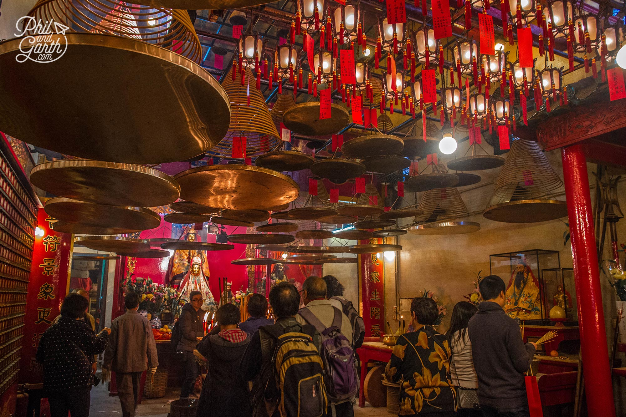 So many conical incense rings are suspended with circular pans to collect the ash