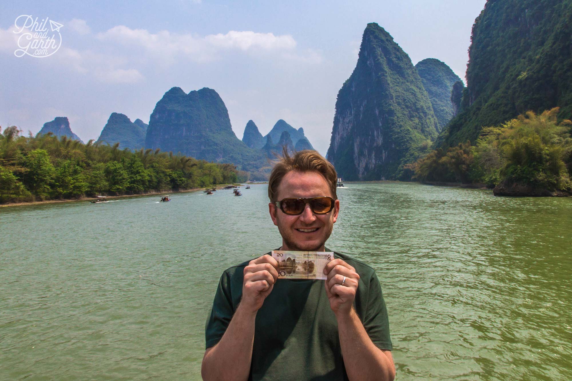 Garth holding a 20 Yuan note passing Xingping, the location featured on the banknote