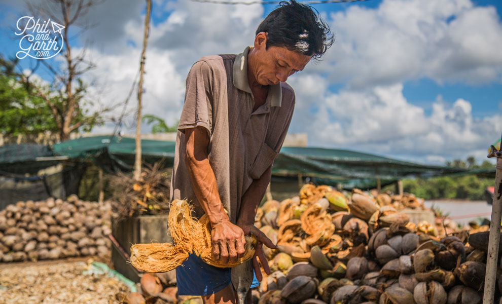 Worker removing the coconut husks