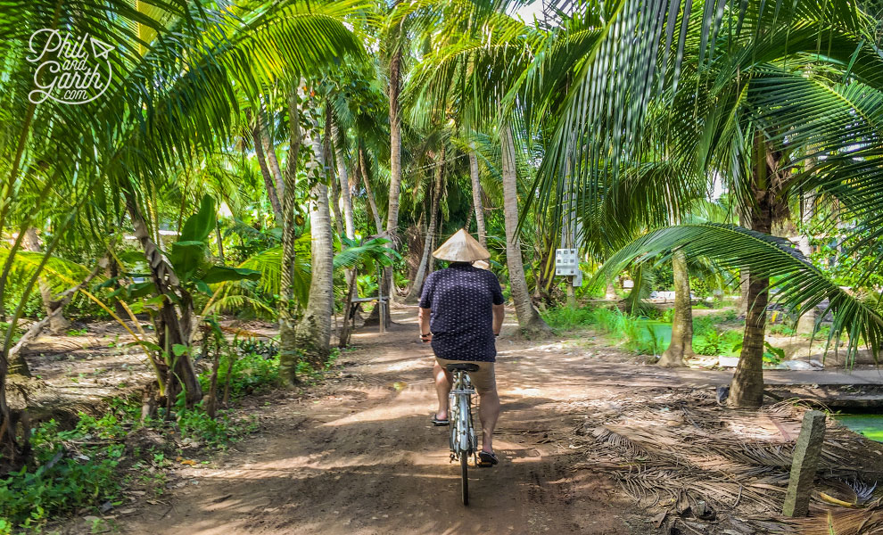 Phil cycling to a Delta village through the jungle.