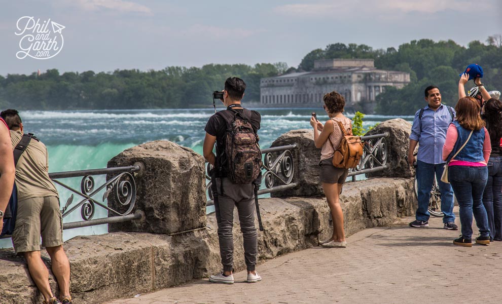 Tourists take photos at the brink