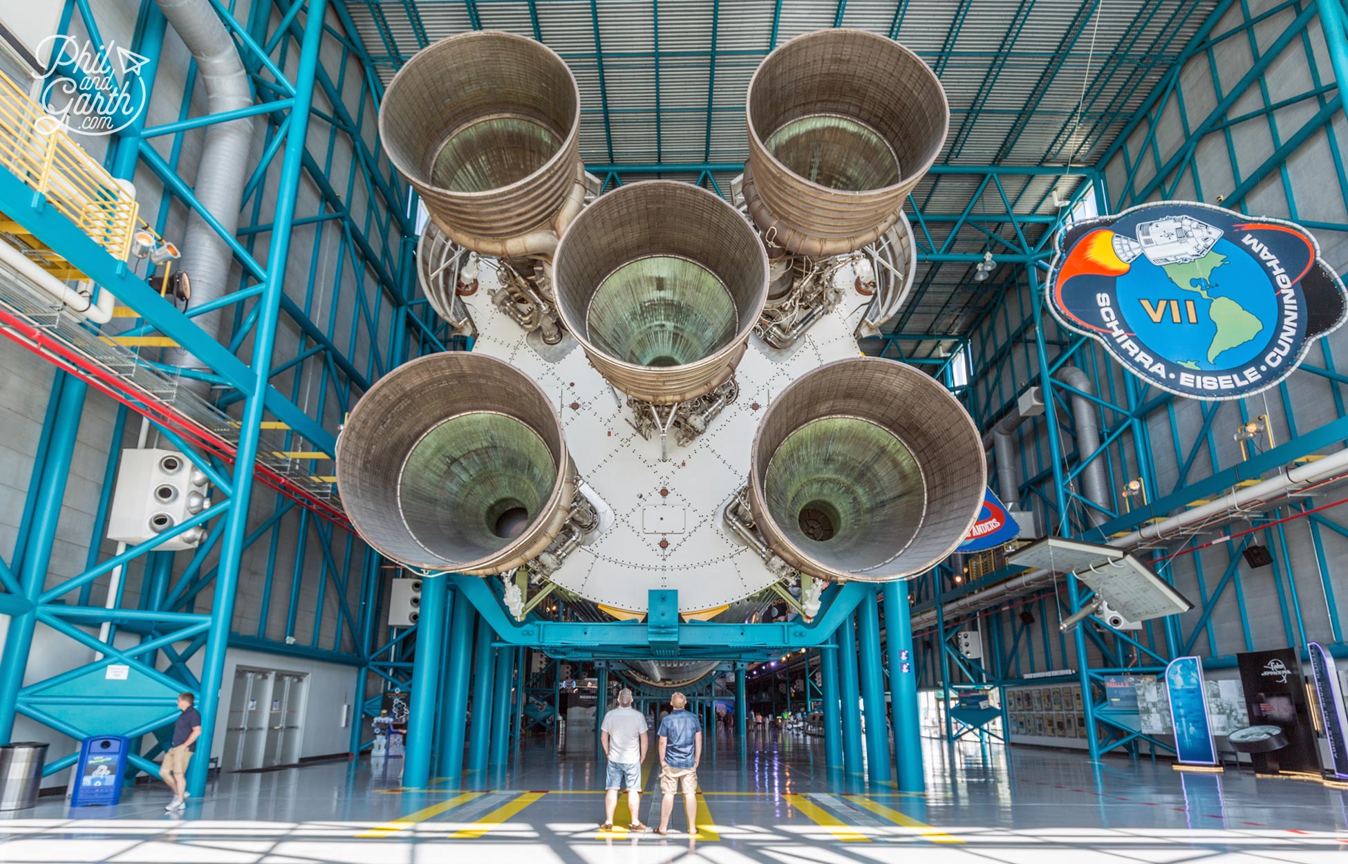 Phil and Garth looking up at the Saturn V Rocket that transferred astronauts to the moon