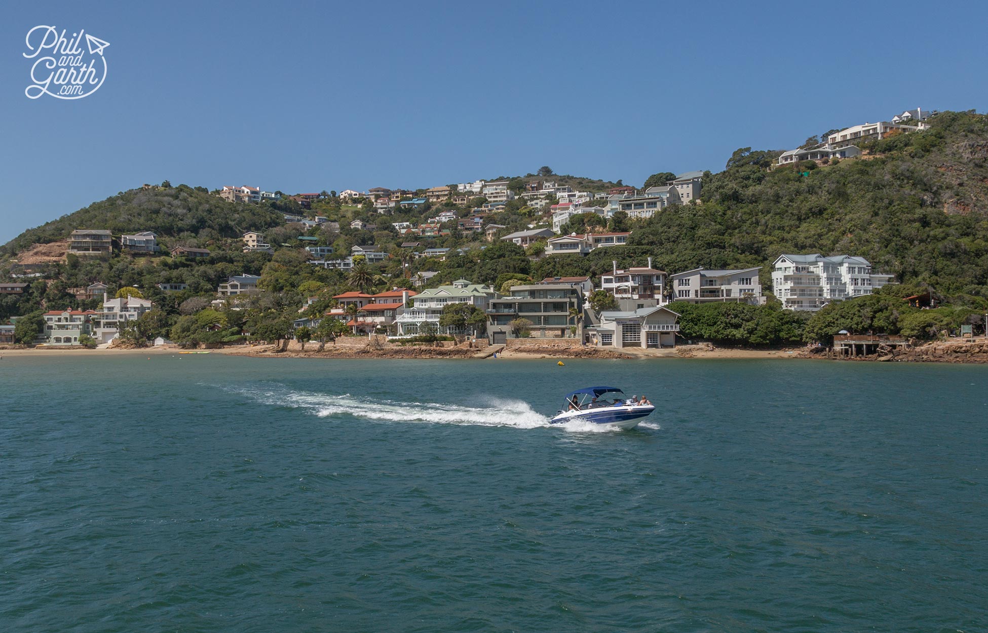 Cruising past rich mansions along Knysna's lagoon