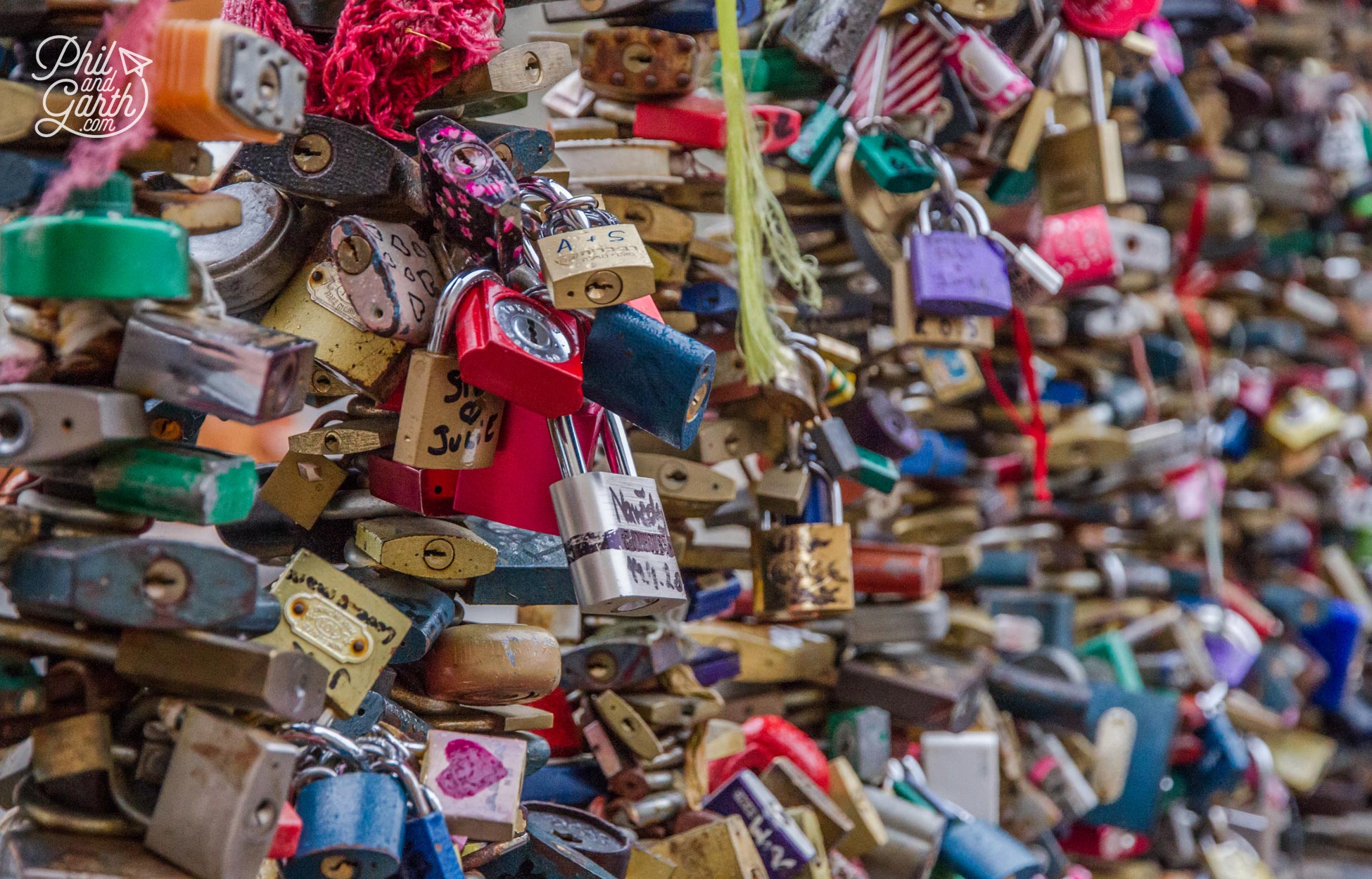 Check out the bridge near John Lennon wall covered in love locks