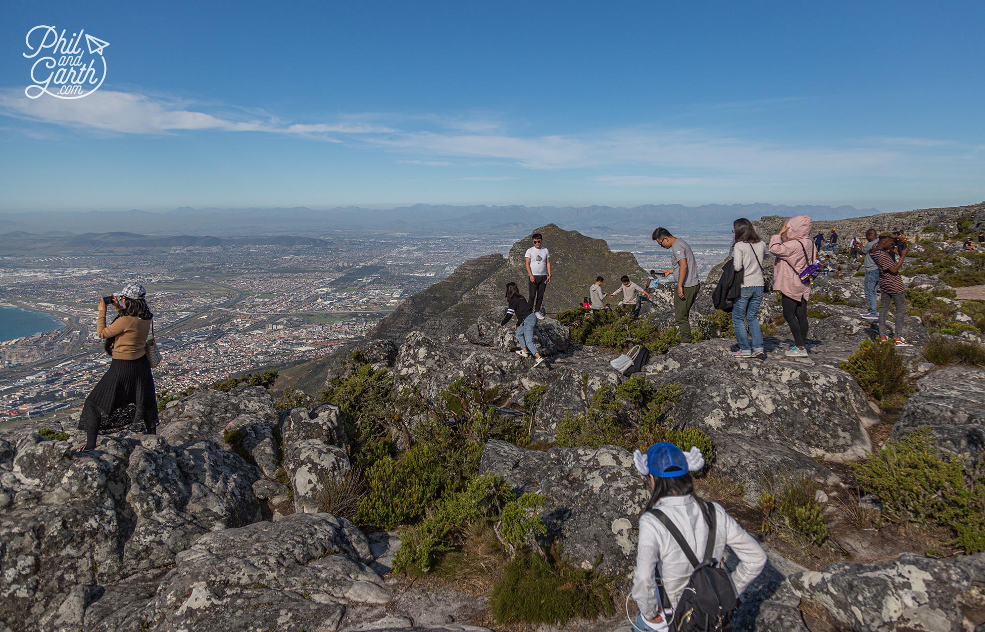 Some people taking death defying photos on the mountain edge!