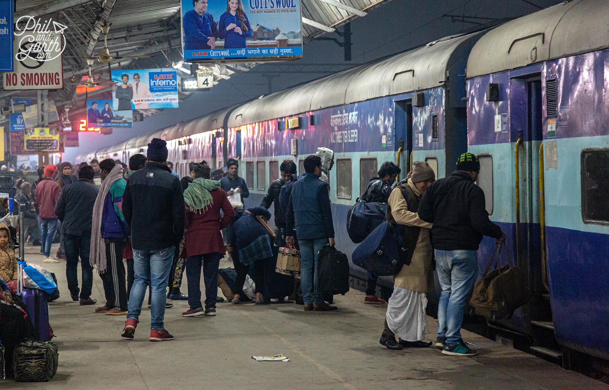 People getting onto a sleeper train in India
