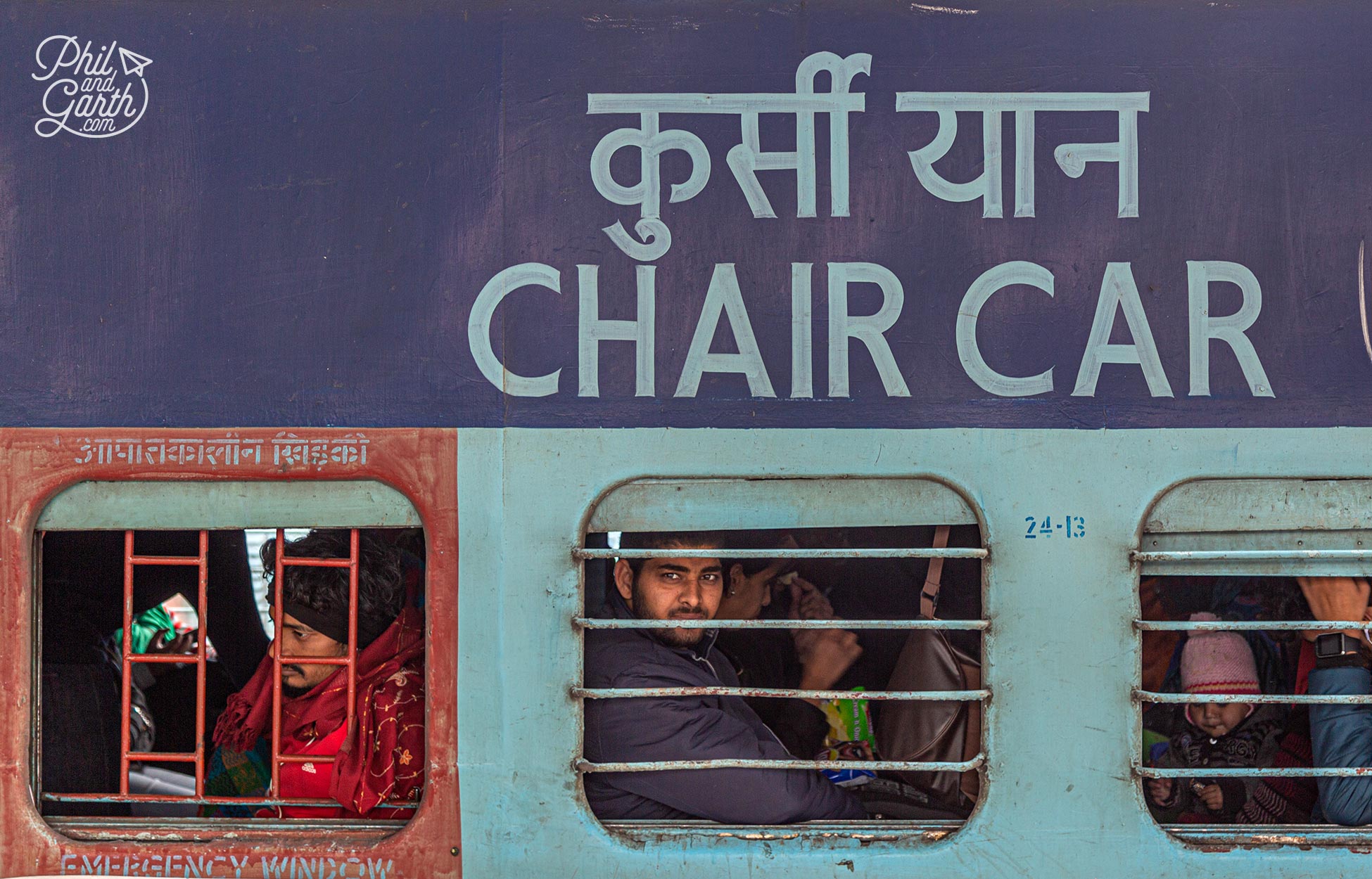 An Indian Railways Chair Class carriage. The bars on the windows are to stop people from outside getting in for free