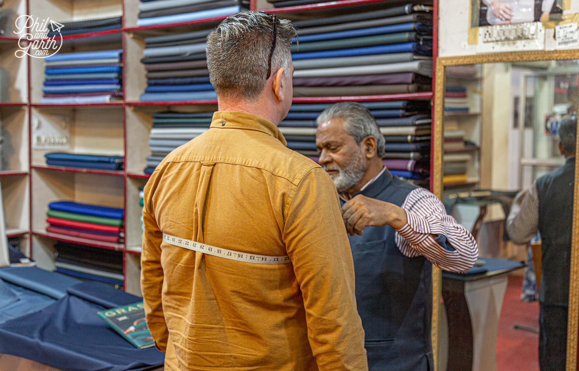 Phil getting measured up for a new suit