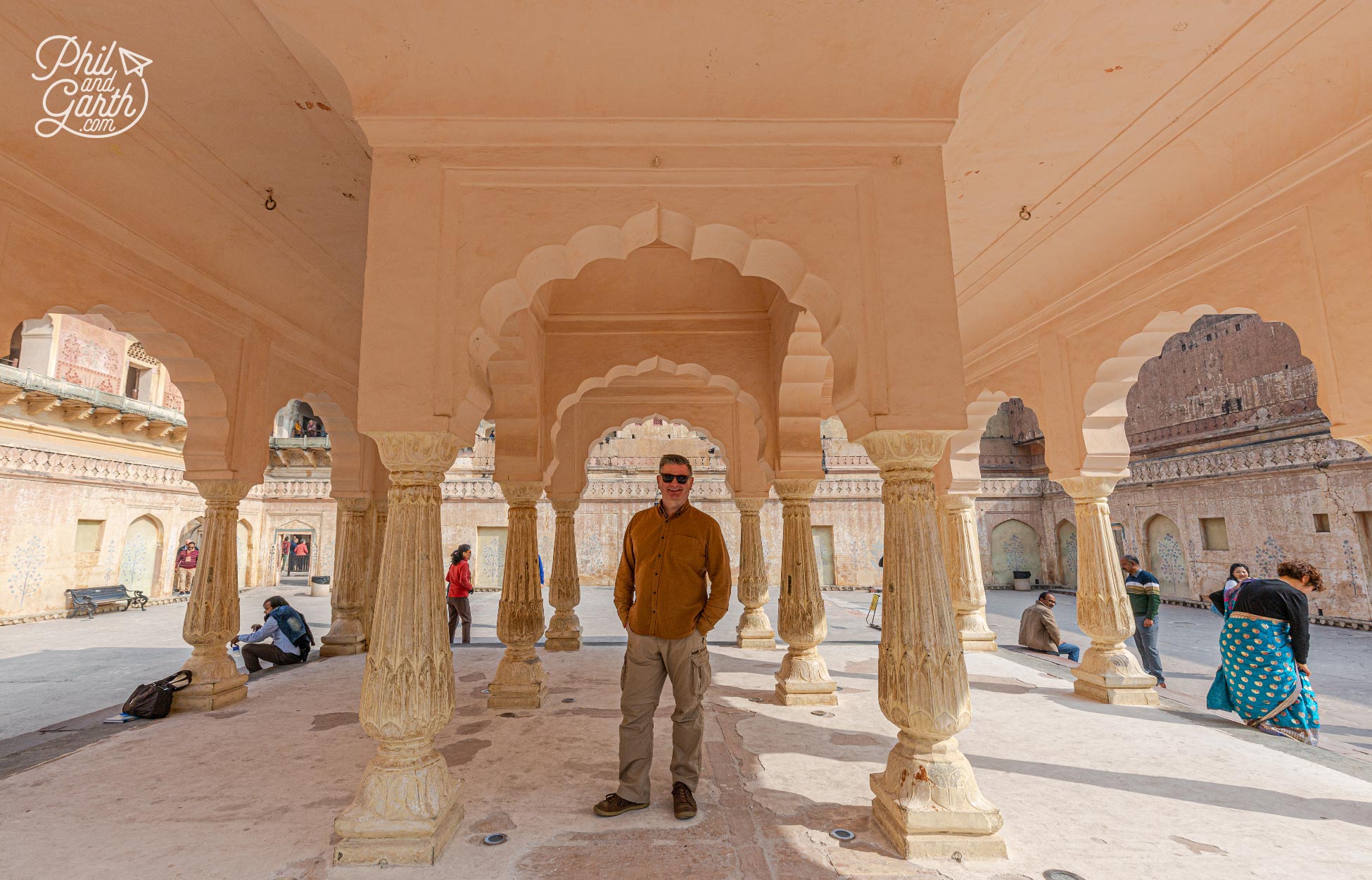 Phil in the shade of the pavilion building