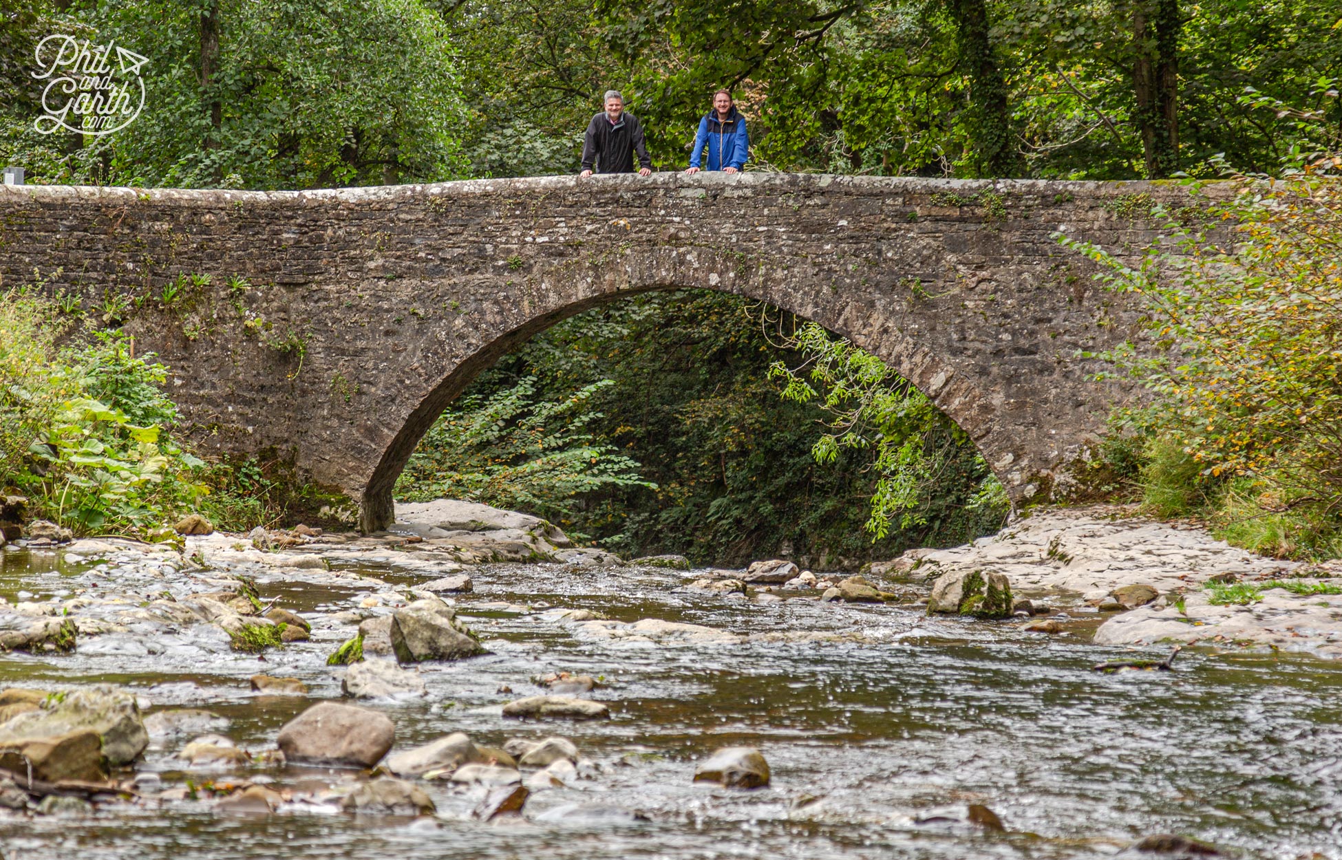 Phil and Garth stood on the stone bridge in the village of West Burton