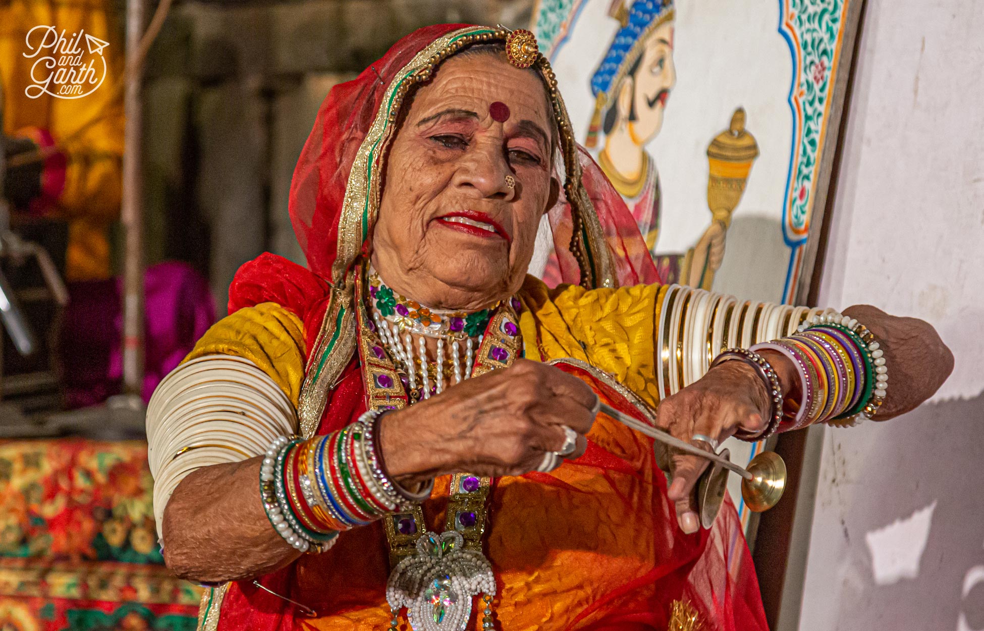 A dance sat down using repetitive movements with bells