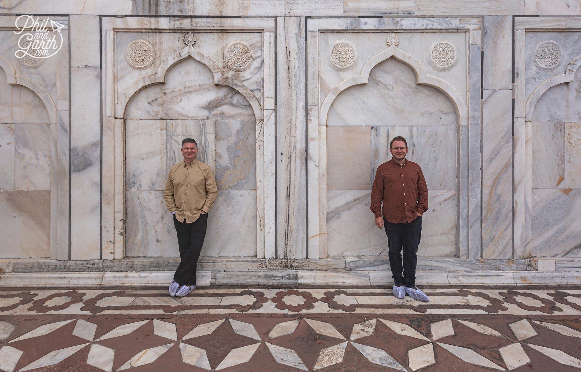 Phil and Garth stood next to a wall of the Taj Mahal