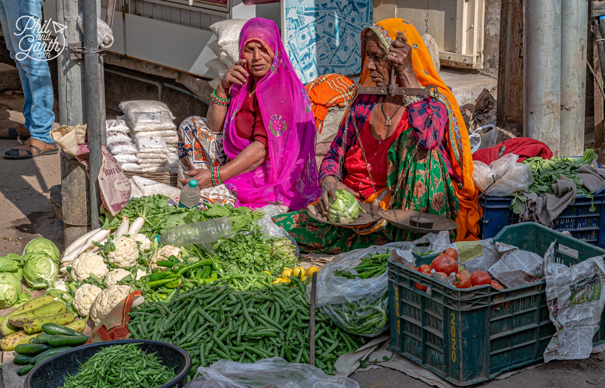 A couple more ladies selling vegetables on a street corner