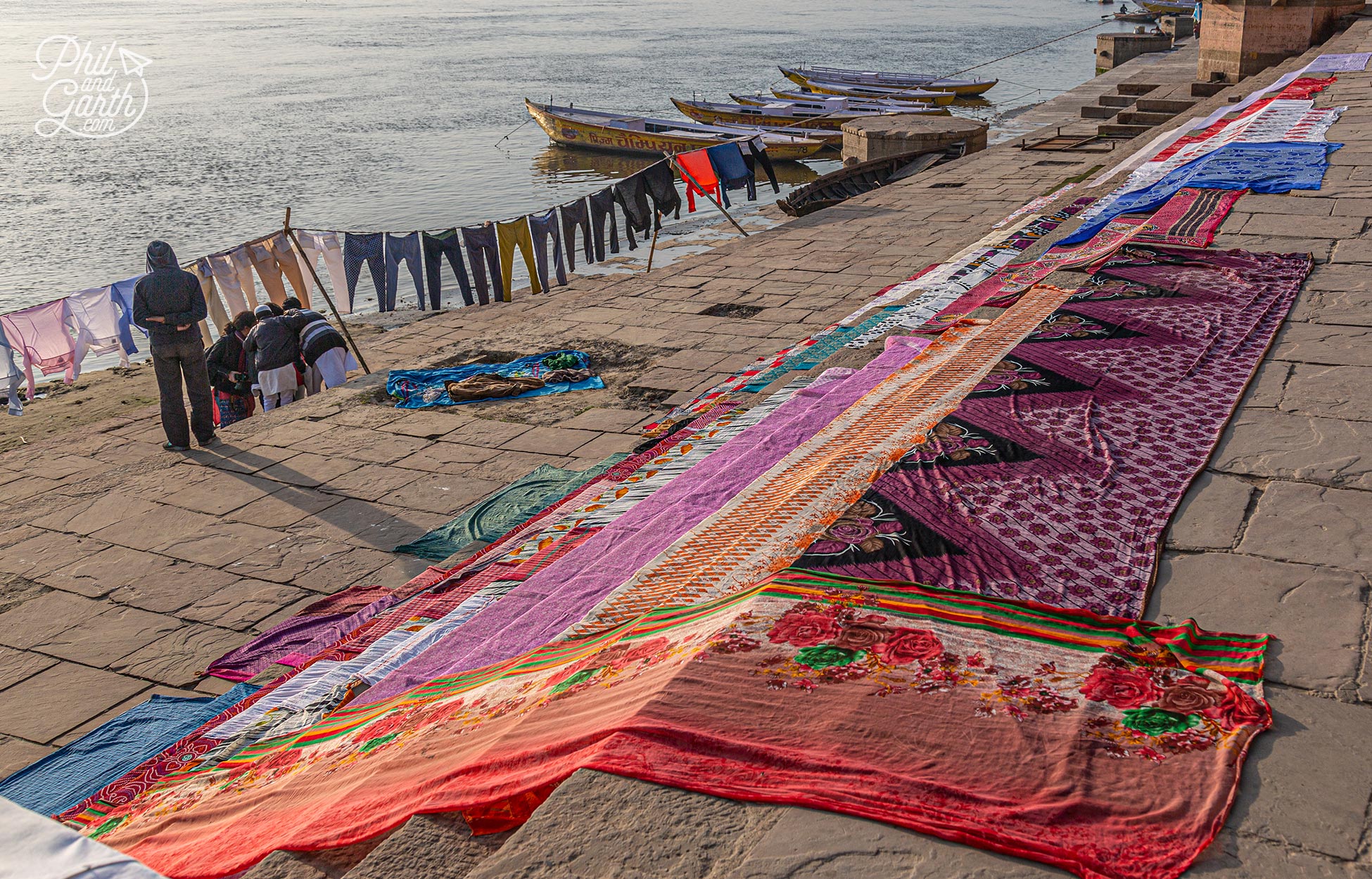 Colourful saris laid out to dry on the ghats