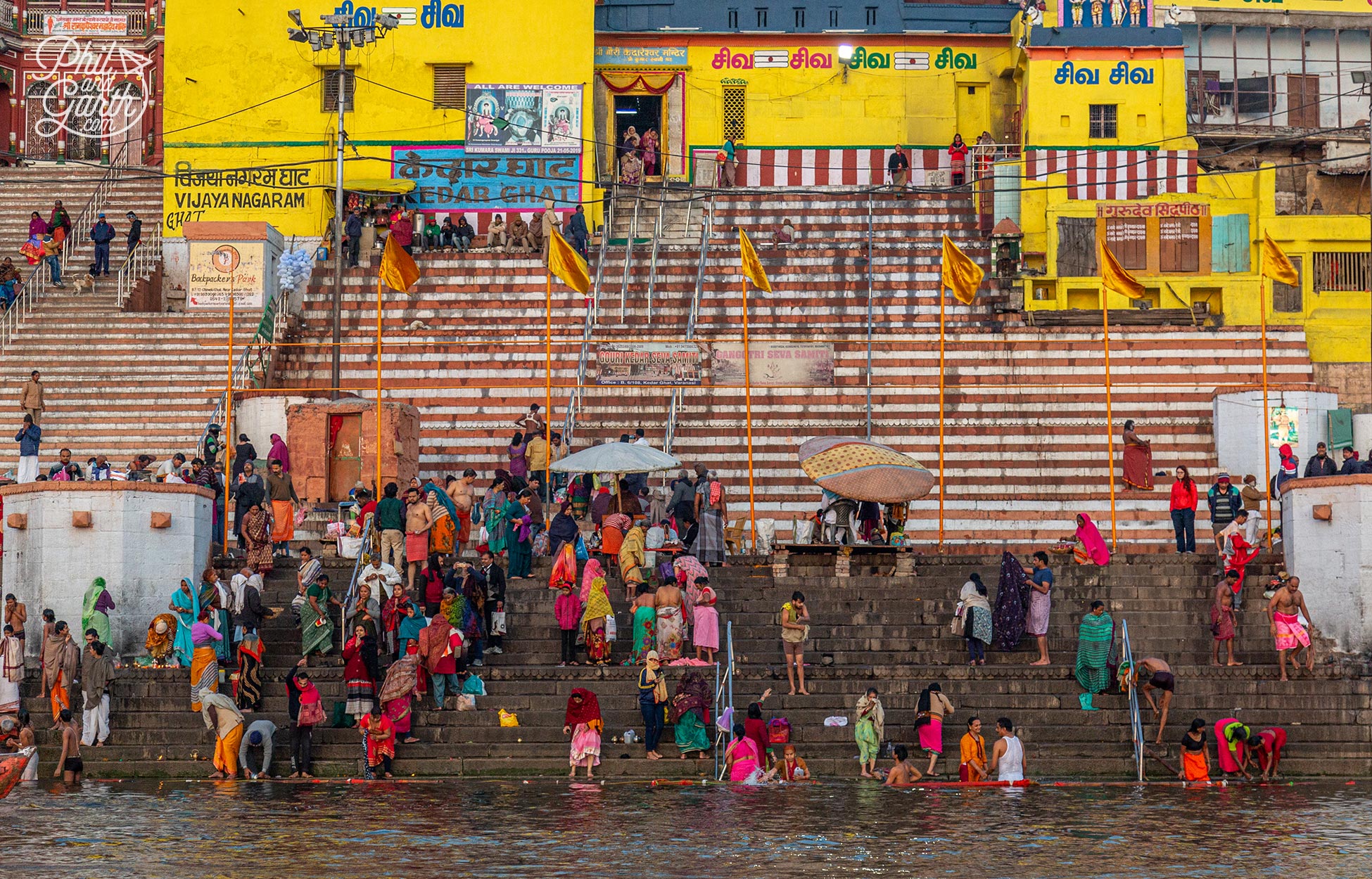 People take dips in the holy water of the River Ganges to wash away sins