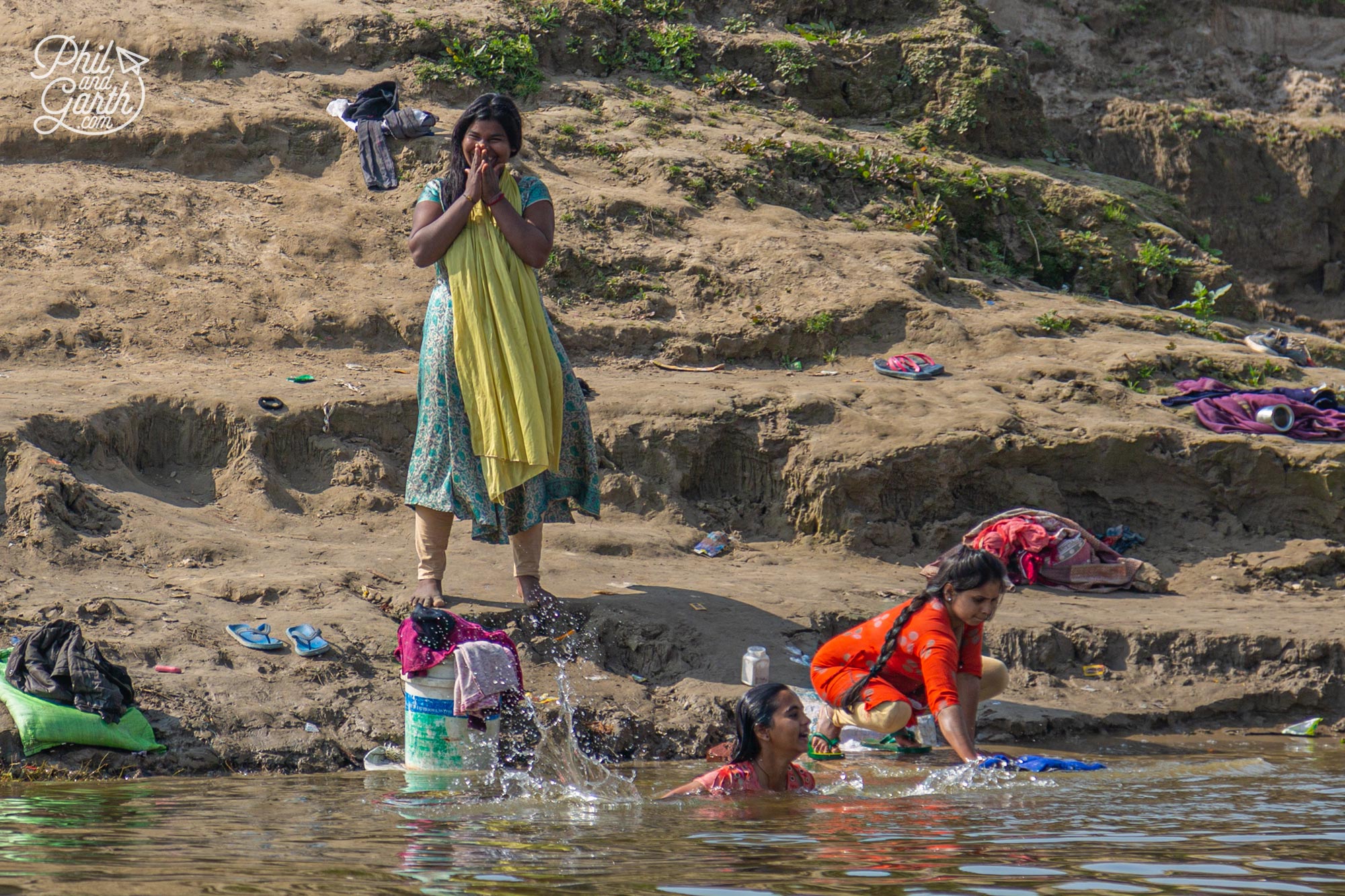 A group of ladies wash and do their laundry in the river