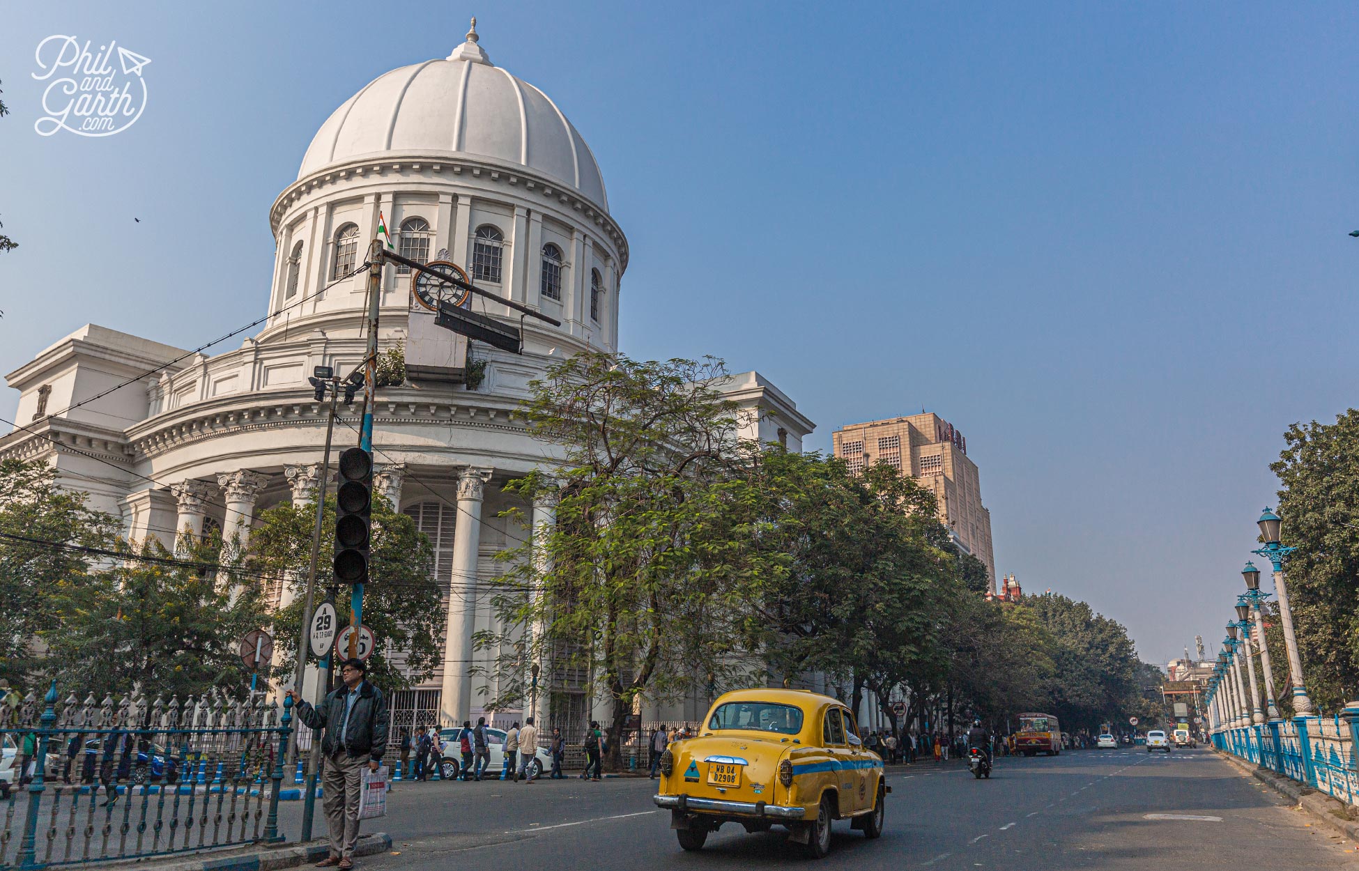 An Ambassador yellow taxi drives past the General Post Office. It was built in 1865