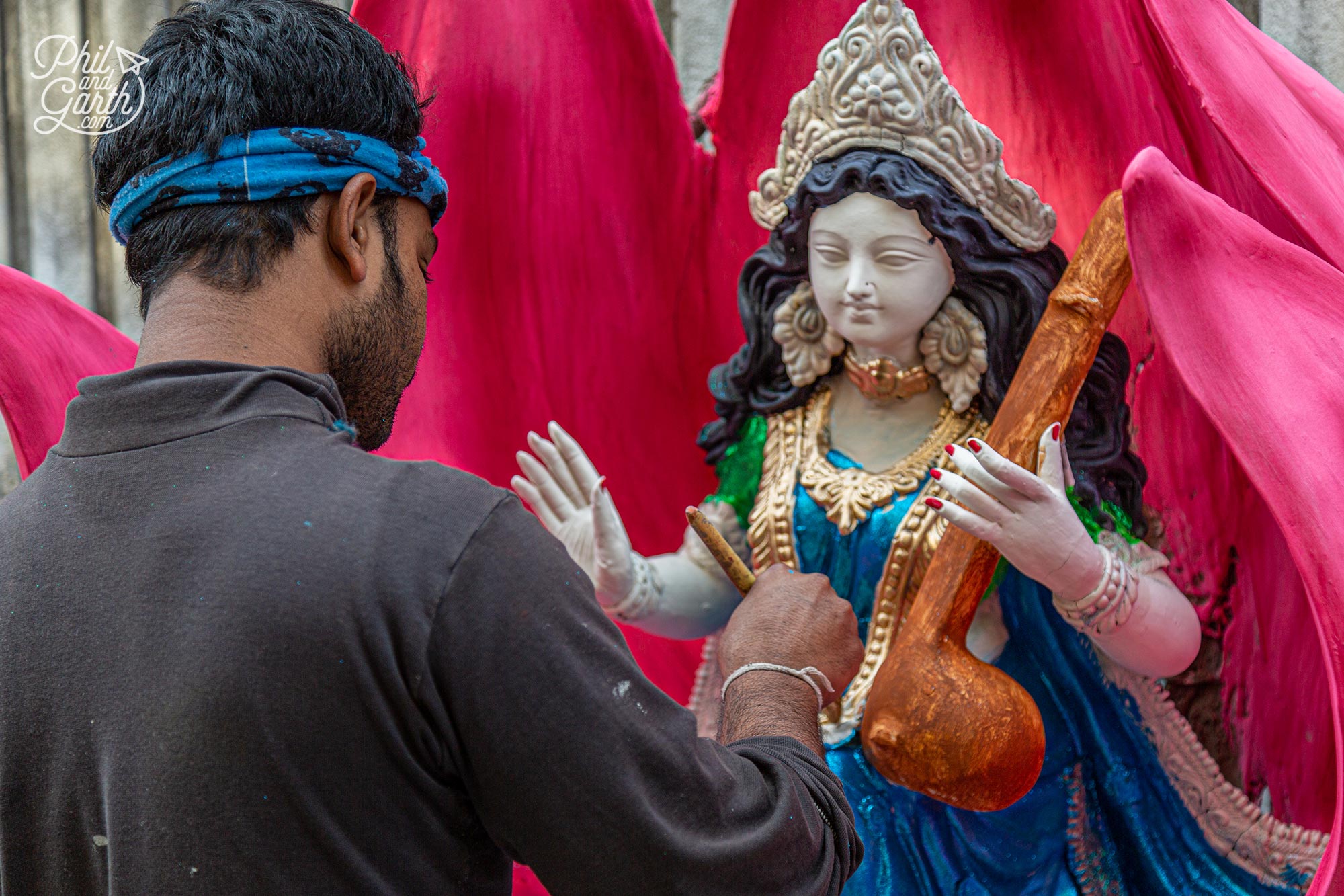 Handpainting a statue of Goddess Saraswati