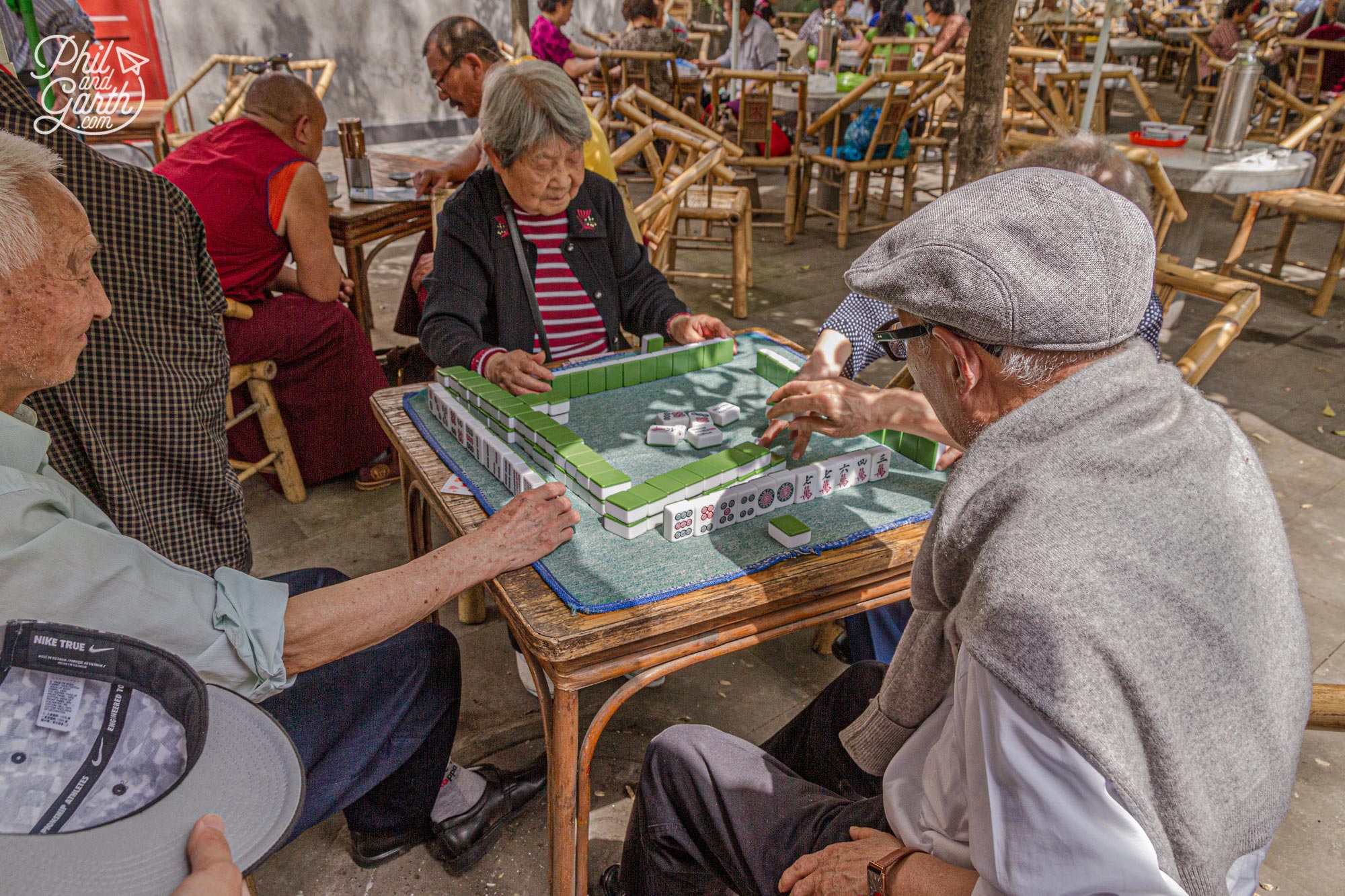 Friends playing Mahjong - a tile based game invented during the Qing dynasty