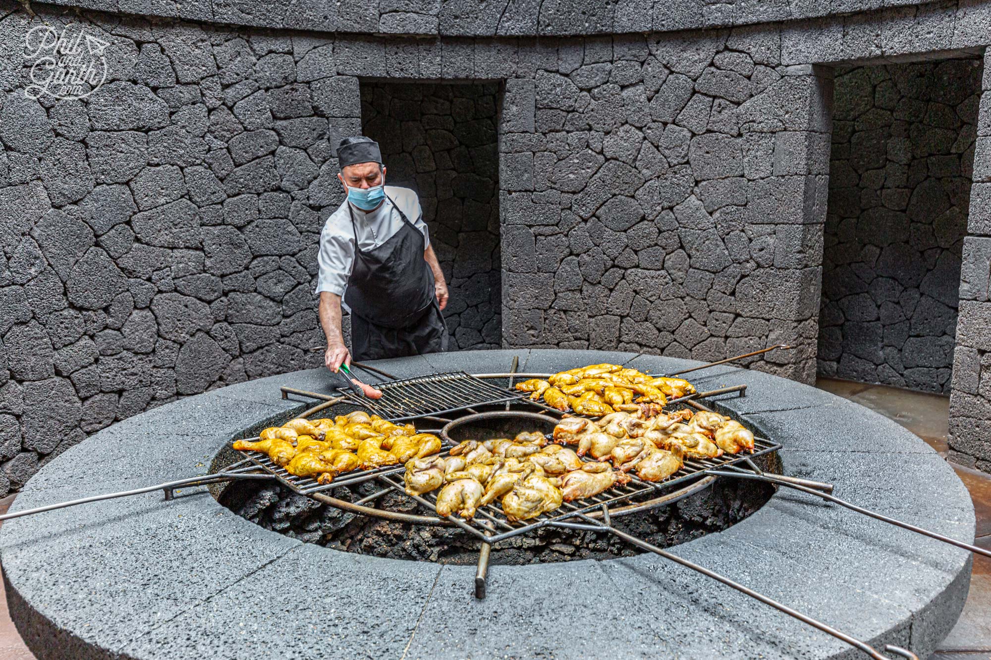 A chef uses the heat from the volcano to cook various meat at the El Diablo restaurant