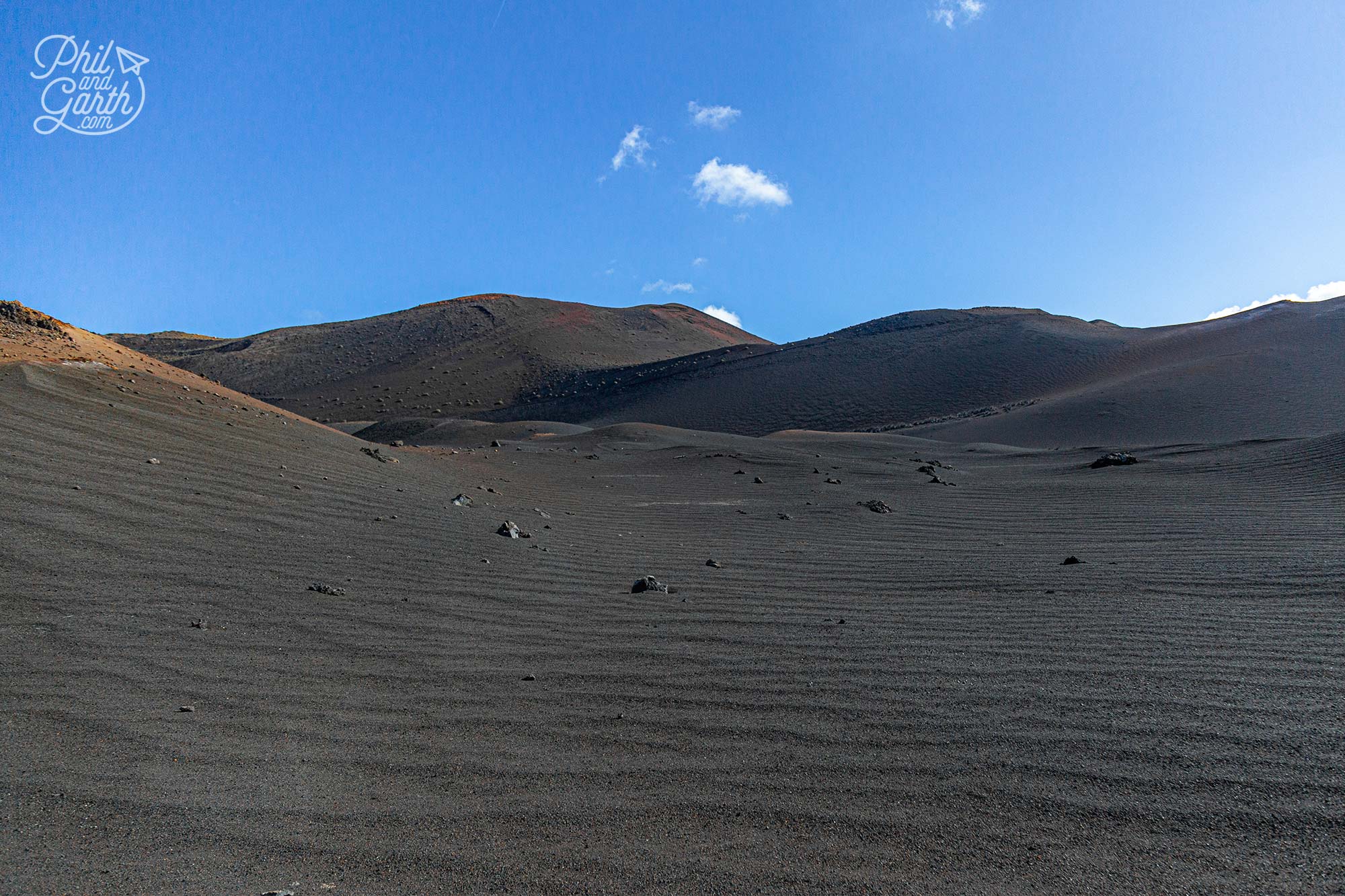 Barren lava plains covered in black volcanic ash