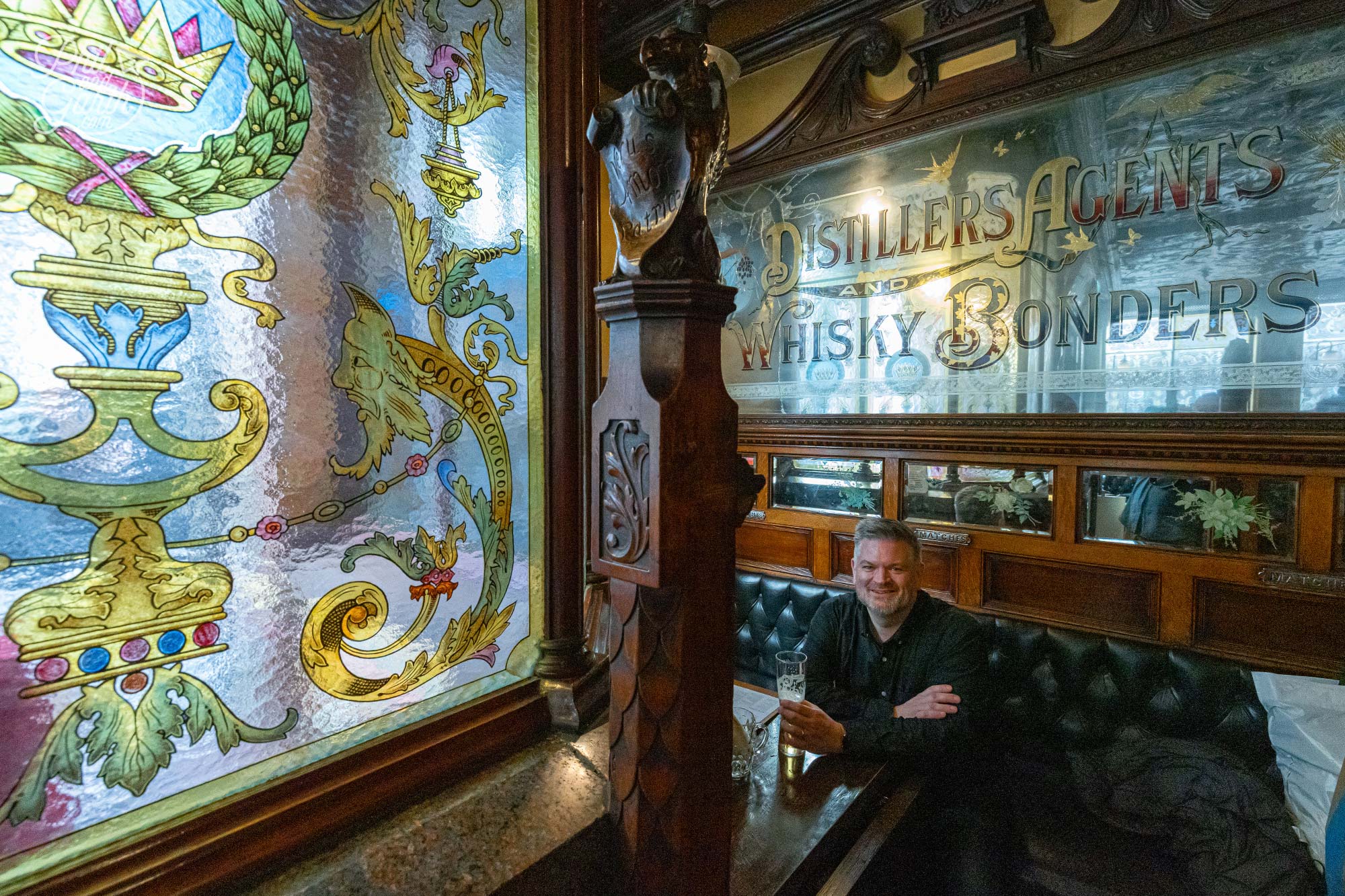 Phil enjoying a drink inside one of the cozy booths