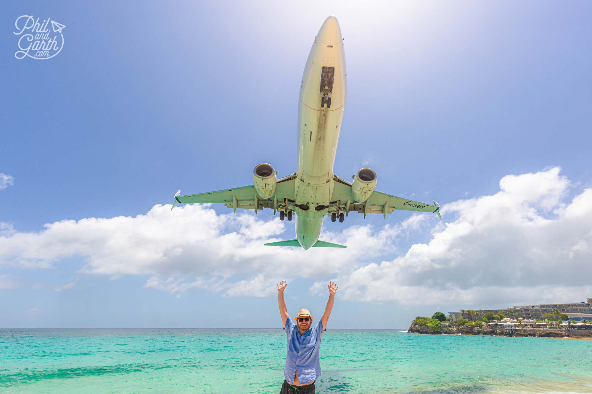 Garth on Maho Beach as a plane comes into land