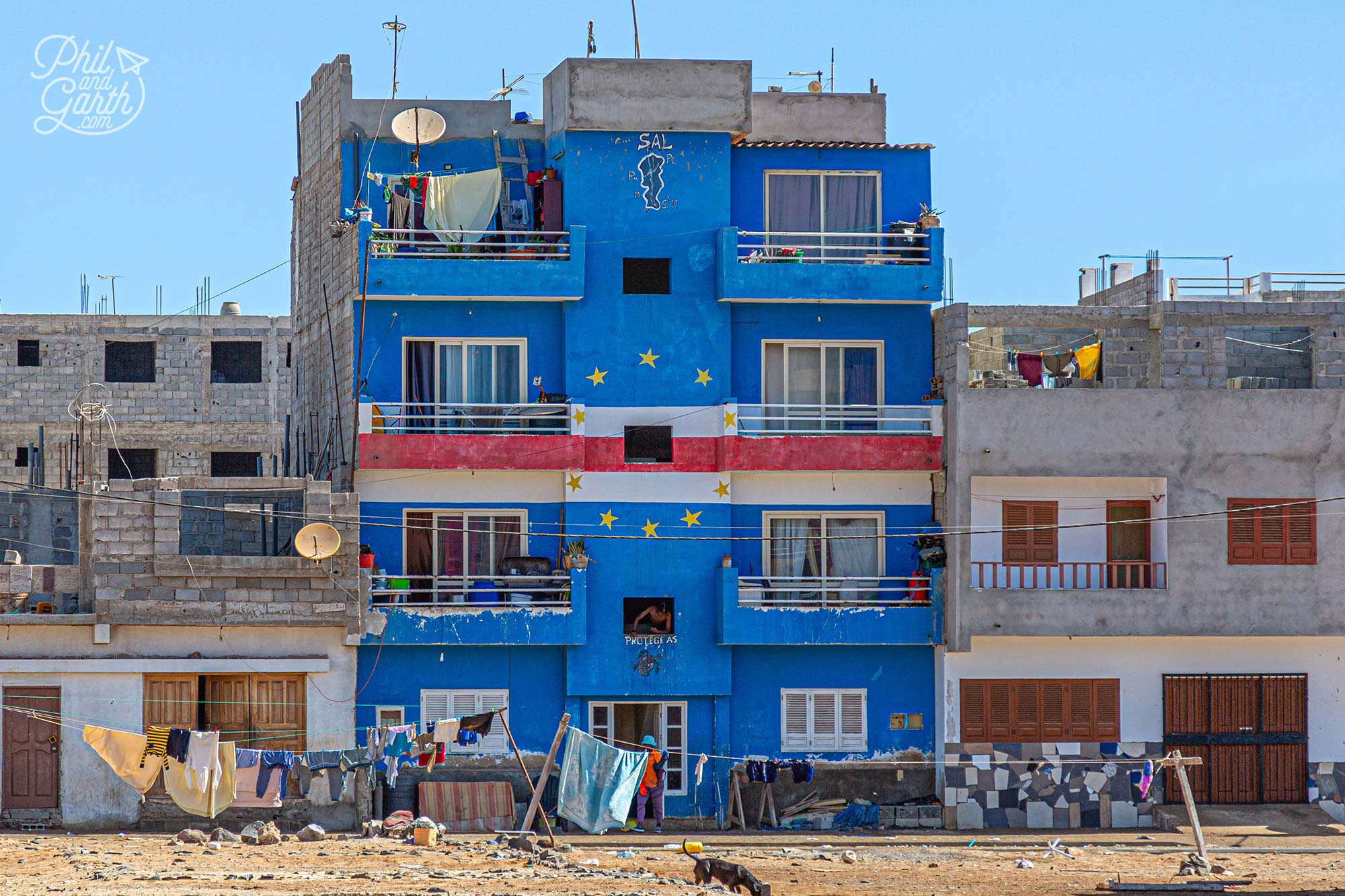 An apartment block with a mural of the Cape Verde flag