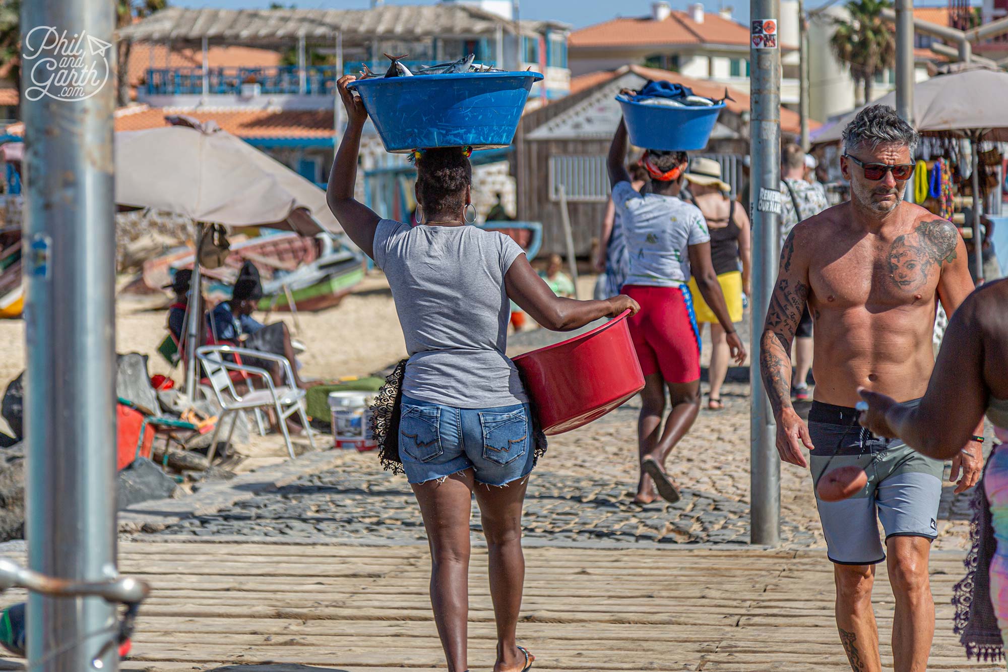 Ladies take away their buckets of fish