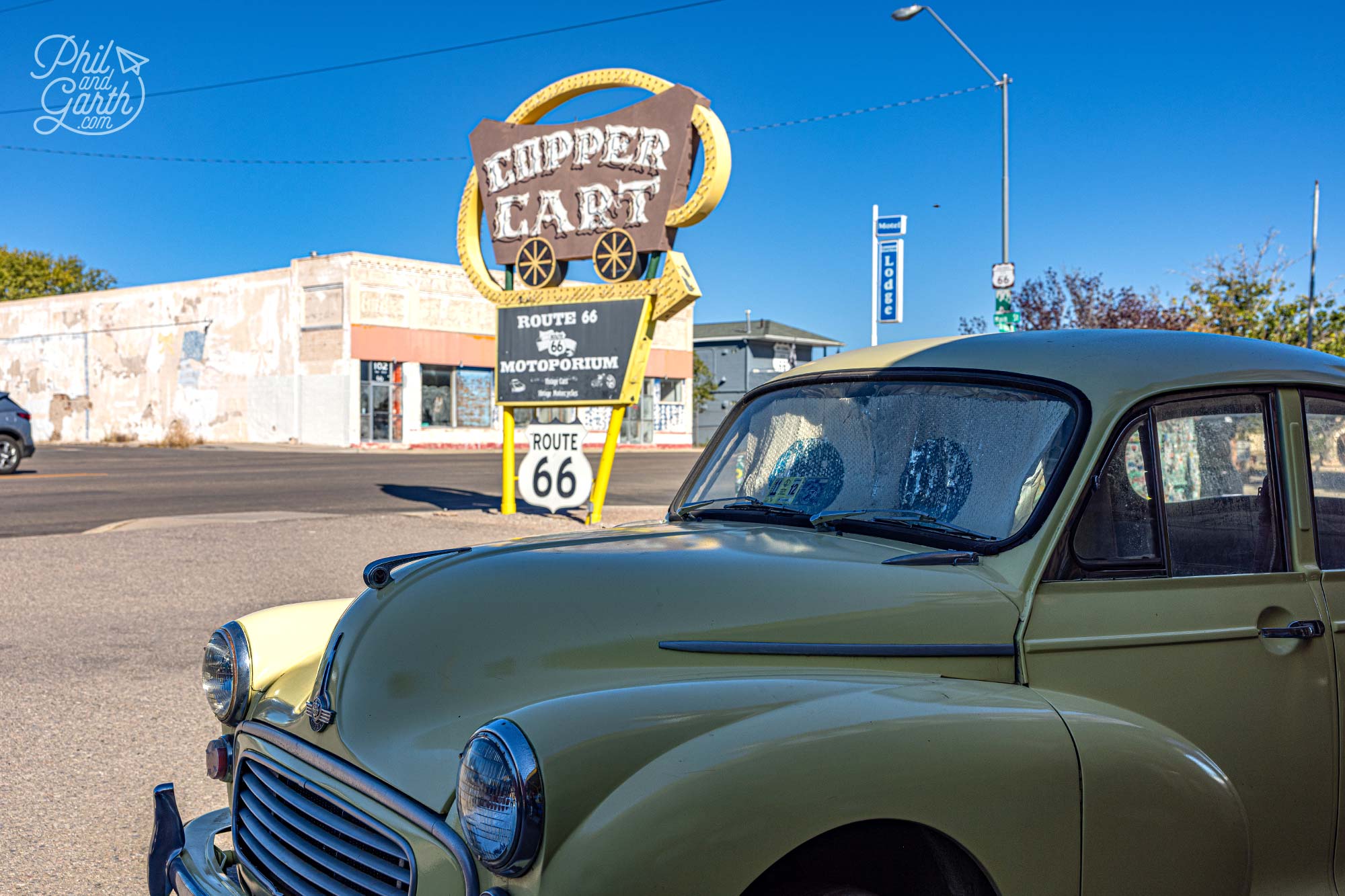 A classic Morris Minor car outside the Cupper Cart Route 66 Motoporium