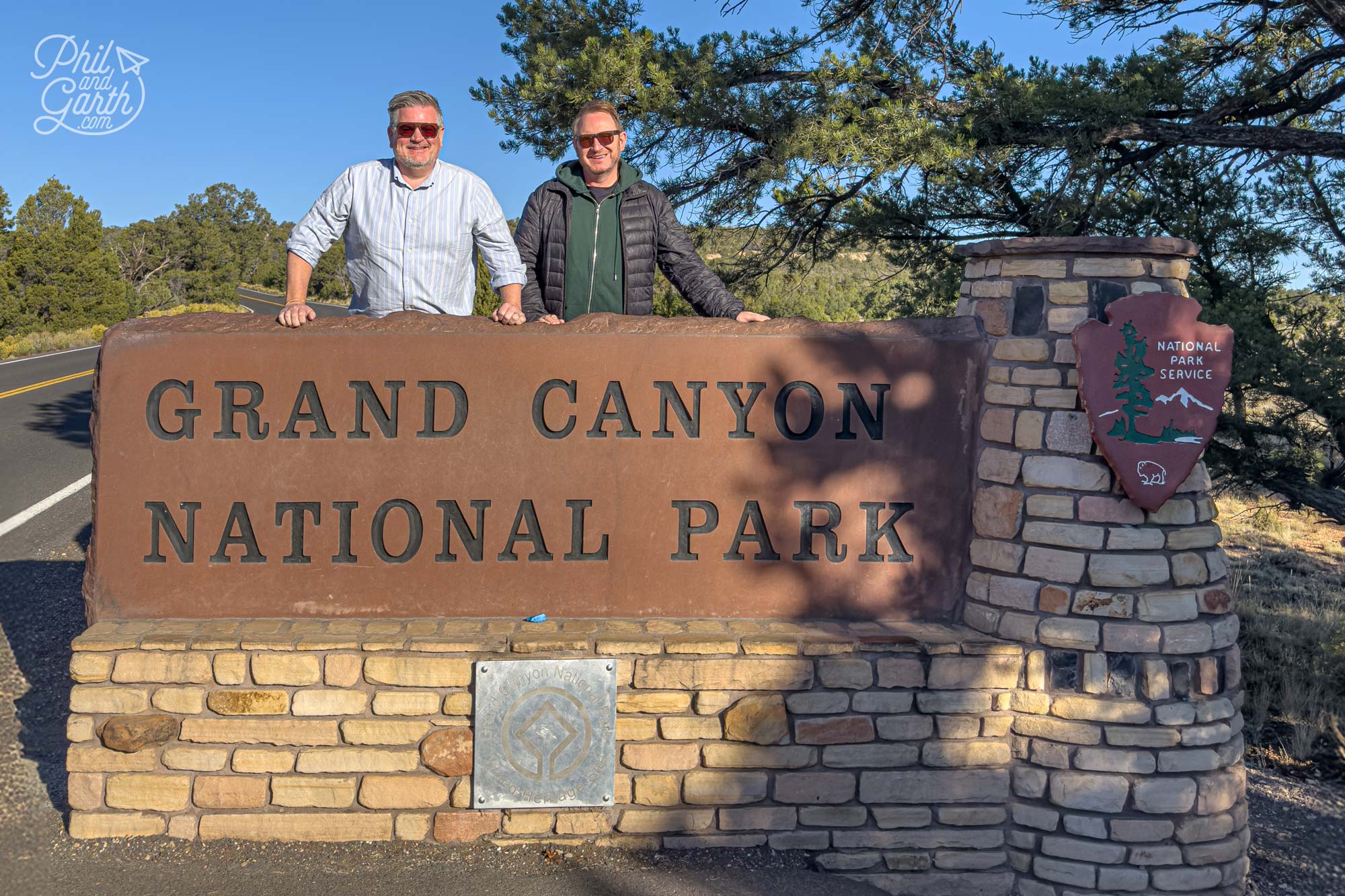 Ken from MaxTour takes a cool photo of us next to the Grand Canyon entrance sign