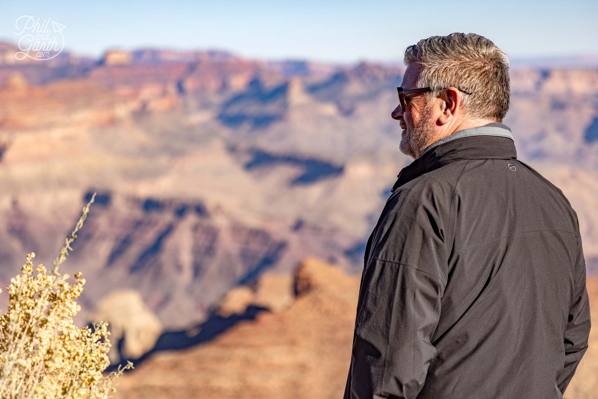 Phil looking at layer after layer of cliffs stretching as far as the eye can see, colours shifting with the early morning light