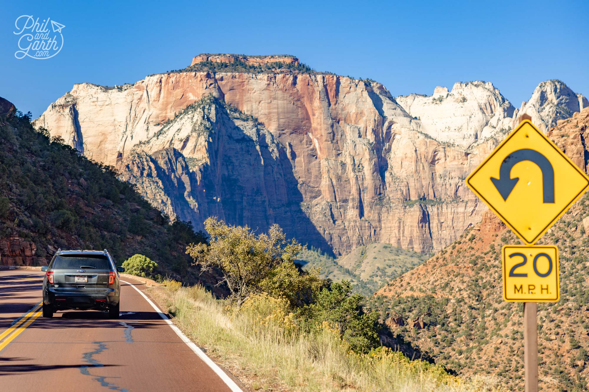 Spectacular roadside view of Zion’s sandstone cliffs under a blue sky