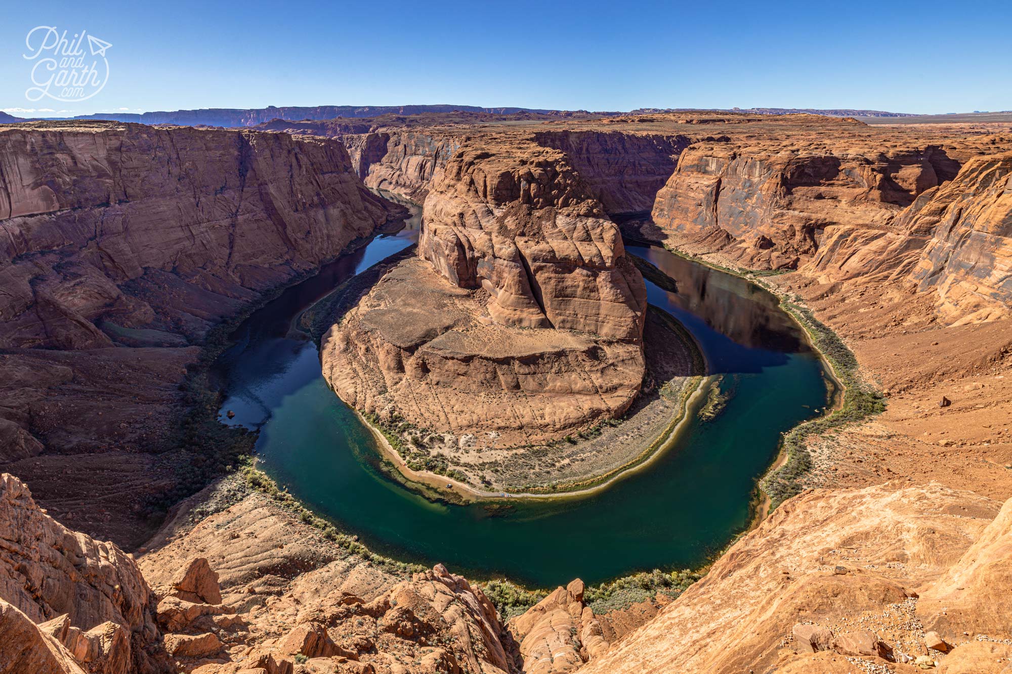 The iconic view of Horseshoe Bend with turquoise water surrounded by red canyon walls