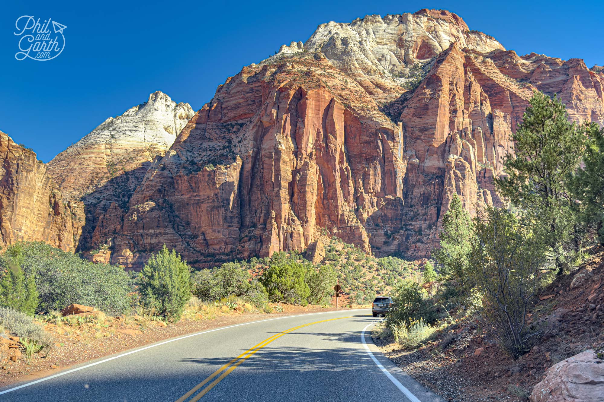 View from the front passenger seat - Contrasting blue sky with red canyon walls in Zion National Park