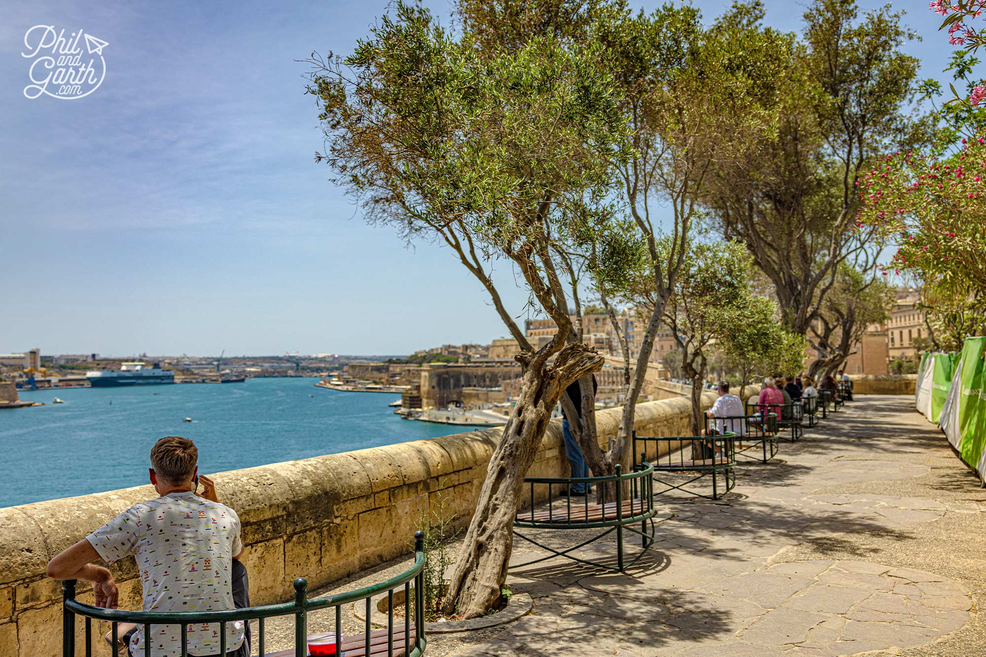 A row of shaded benches overlooking the Mediterranean makes the Lower Barrakka Gardens the perfect place to pause and escape the midday heat