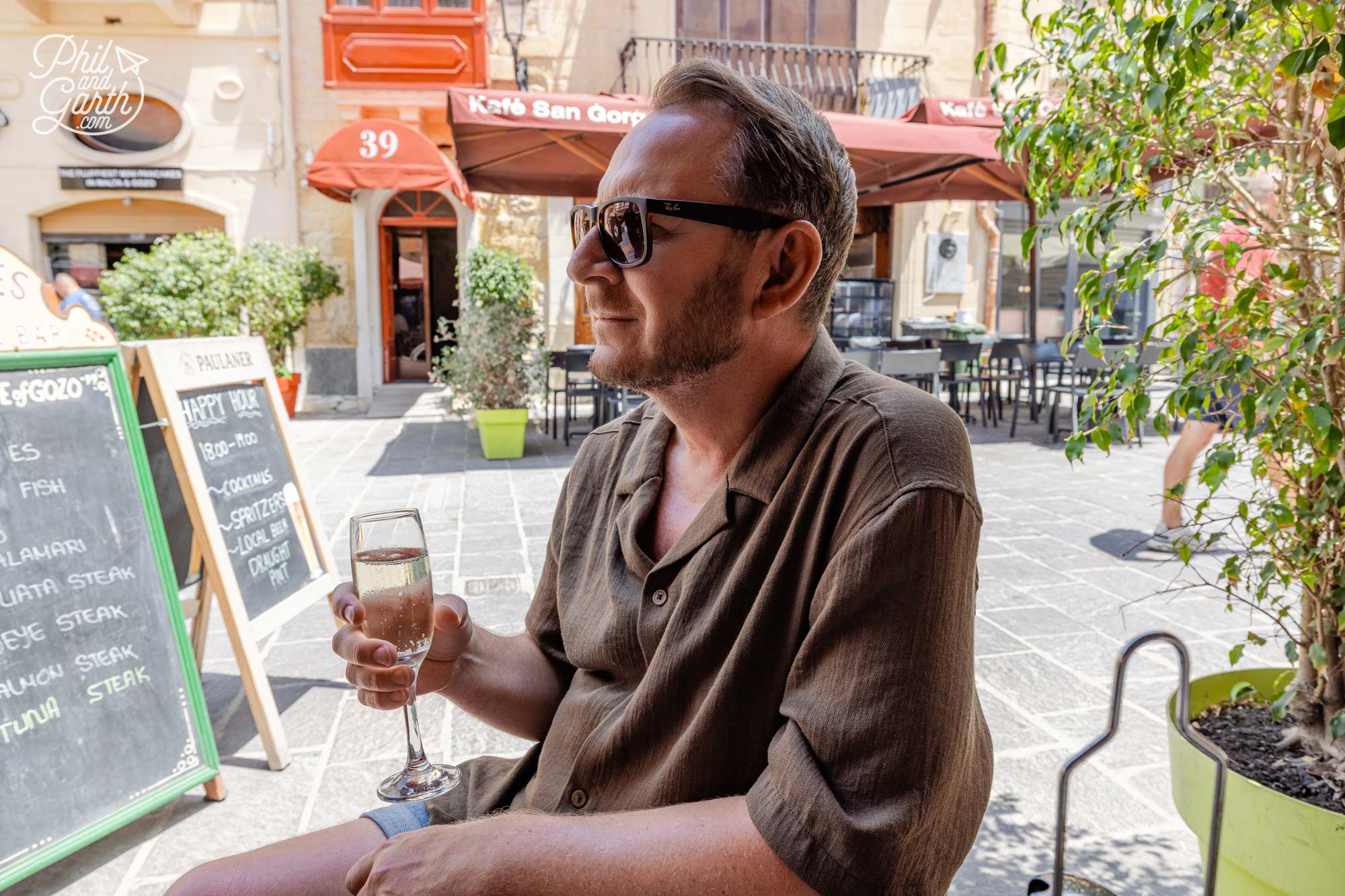 Garth enjoying a glass of prosecco in the shade